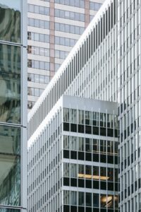 Modern skyscrapers in the city featuring reflective glass facades and urban design.